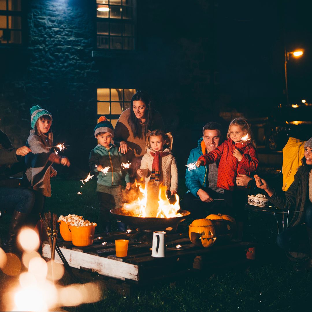 people gathering around a campfire