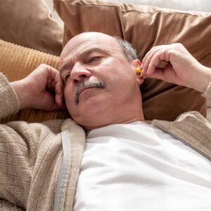 Man wearing earplugs.