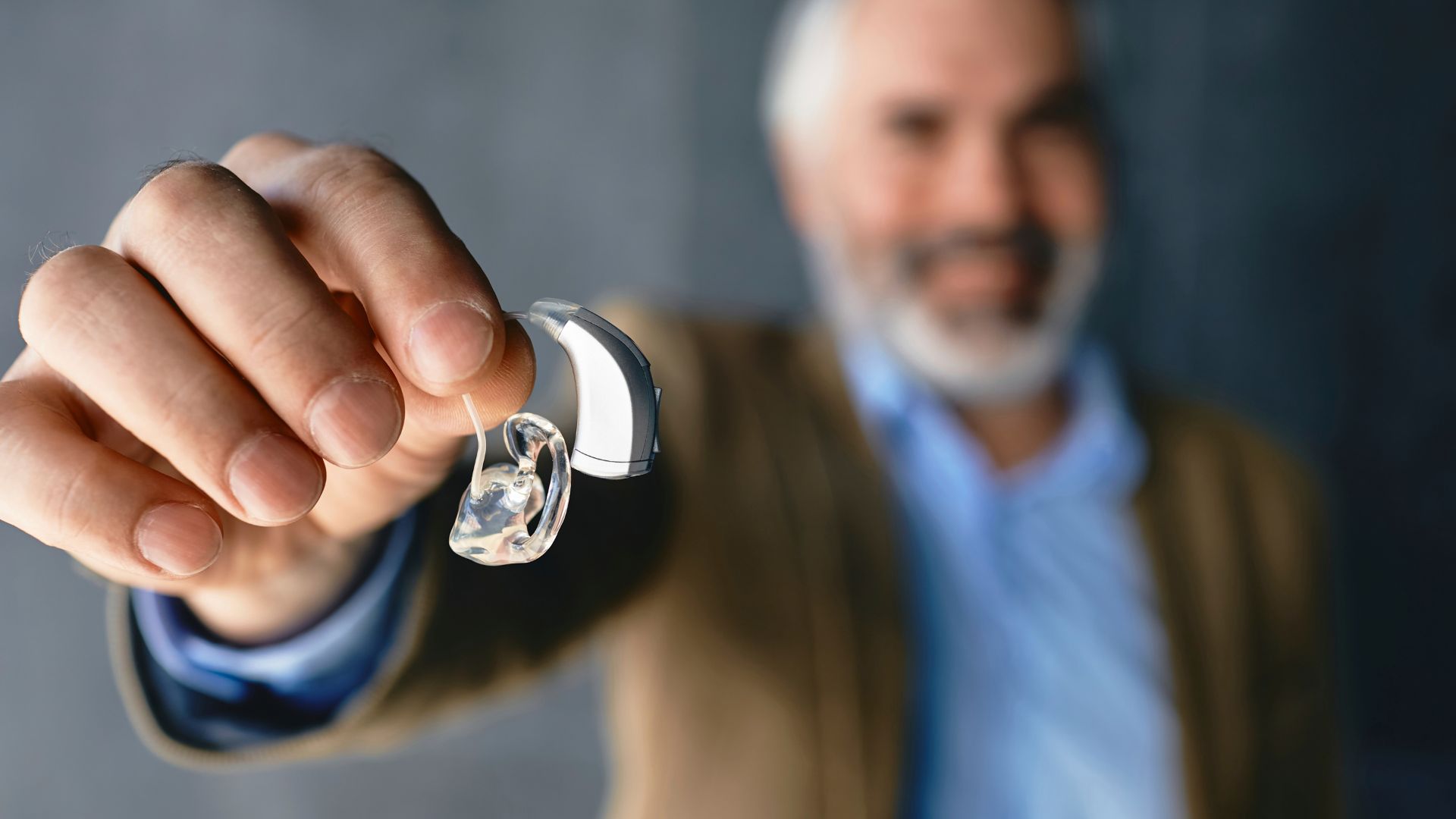 man holding a hearing aid