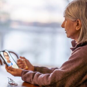 woman on a video call to get hearing aid adjustements