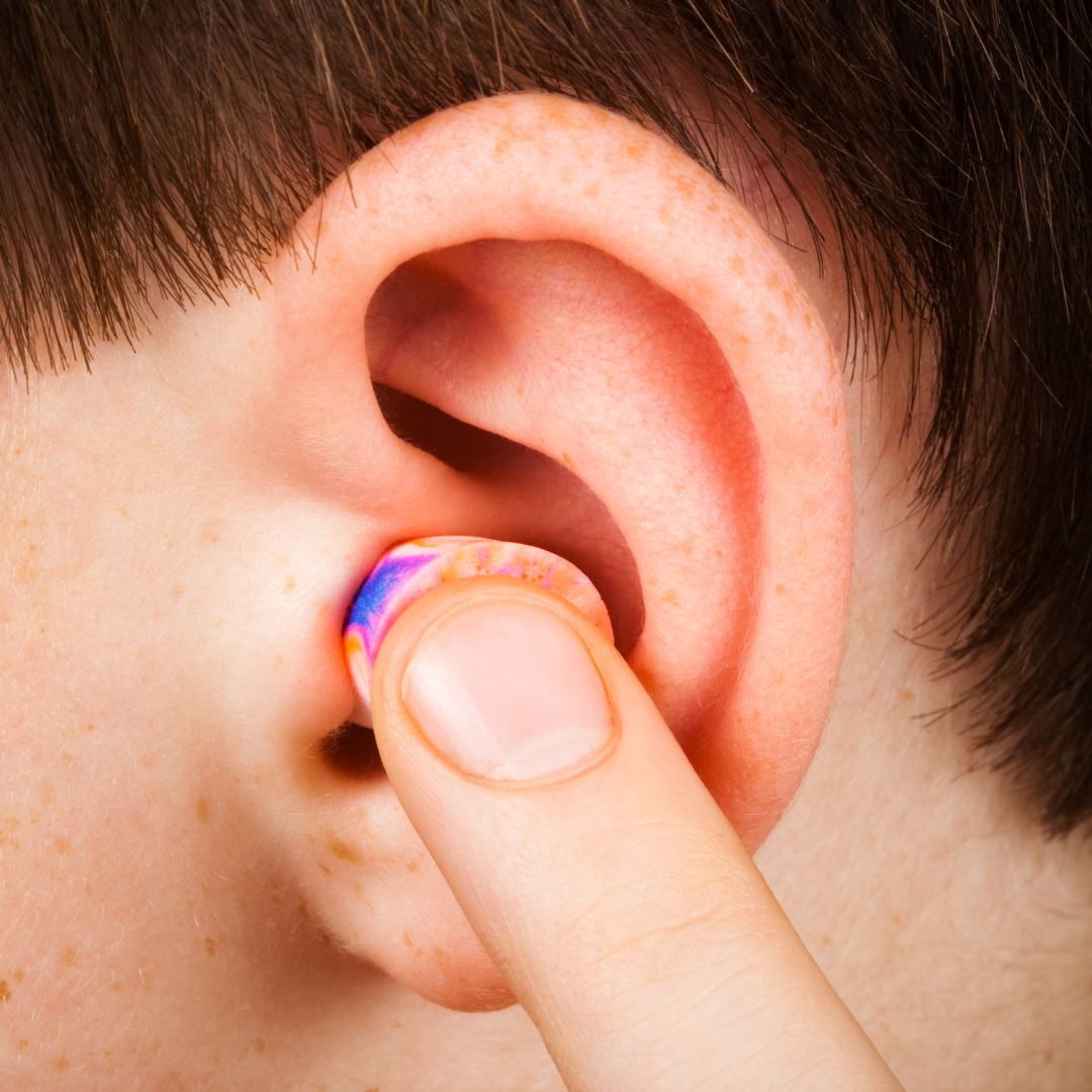 a child putting in an earplug