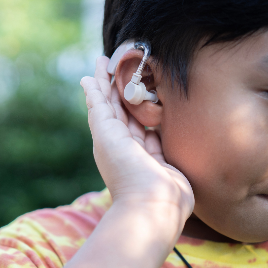child with hearing aid