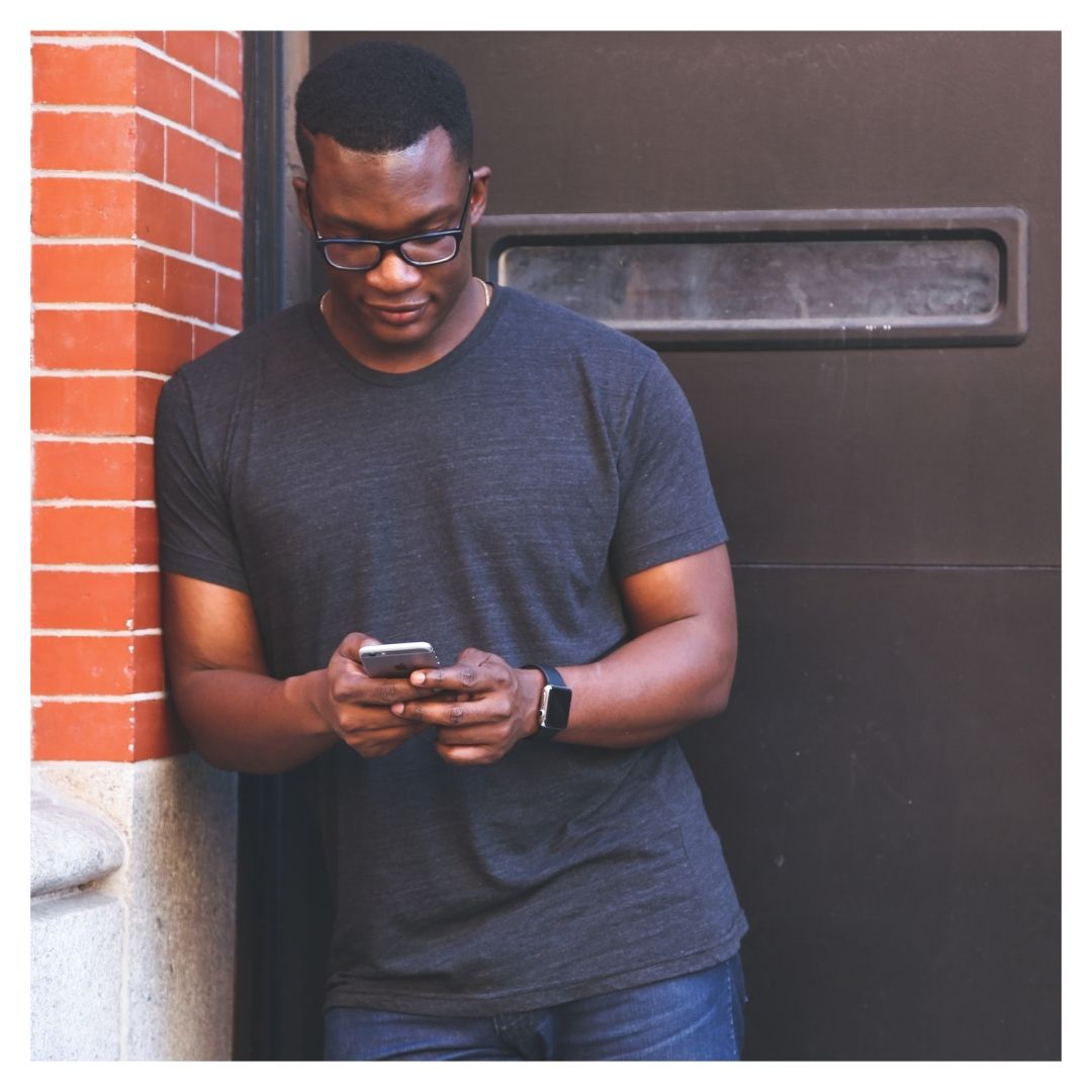 a man texting on the street