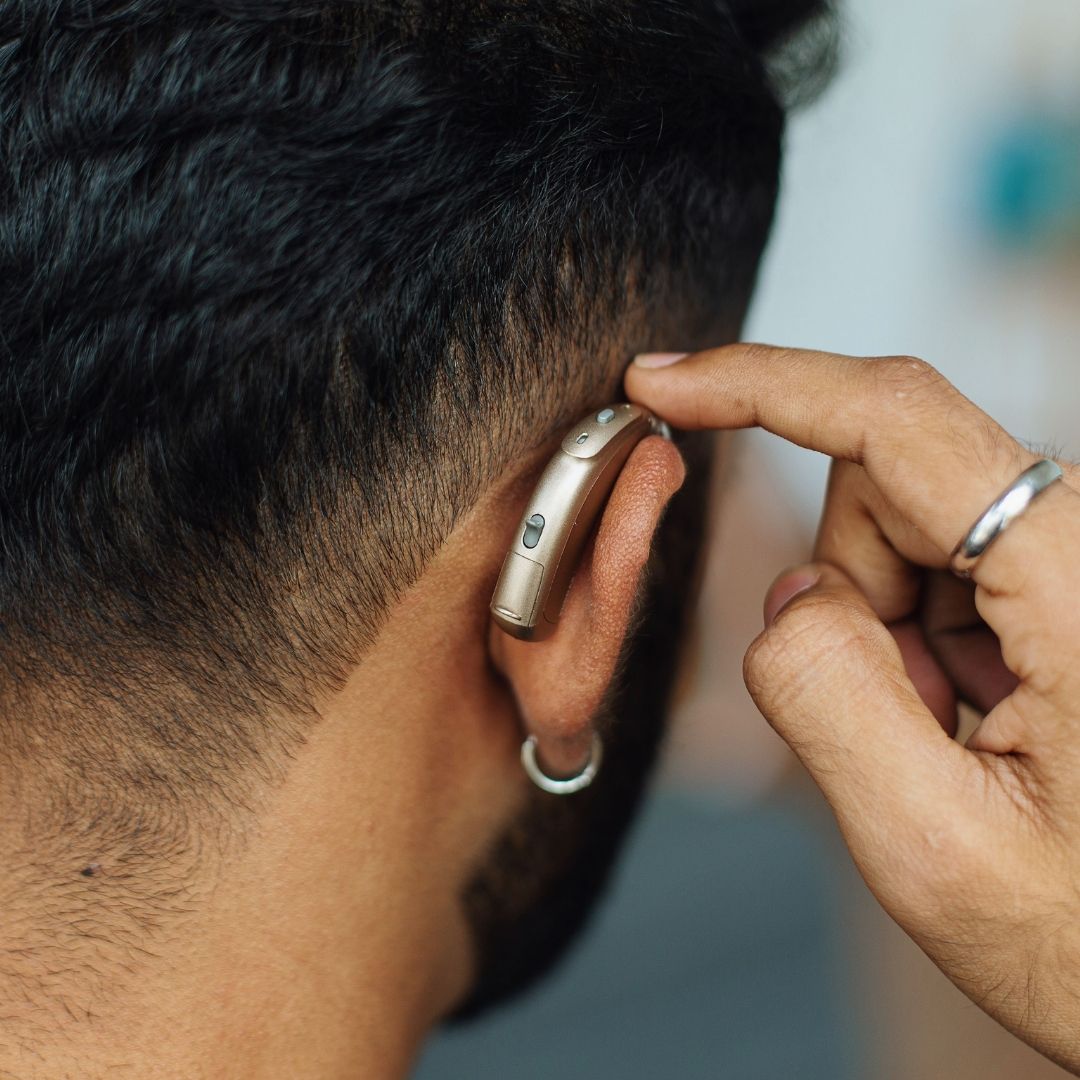 younger man wearing modern hearing aids