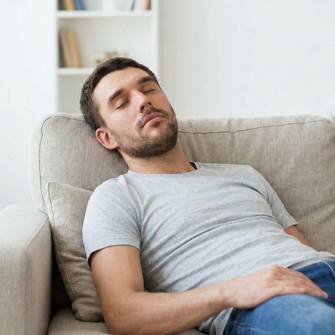 man asleep on couch