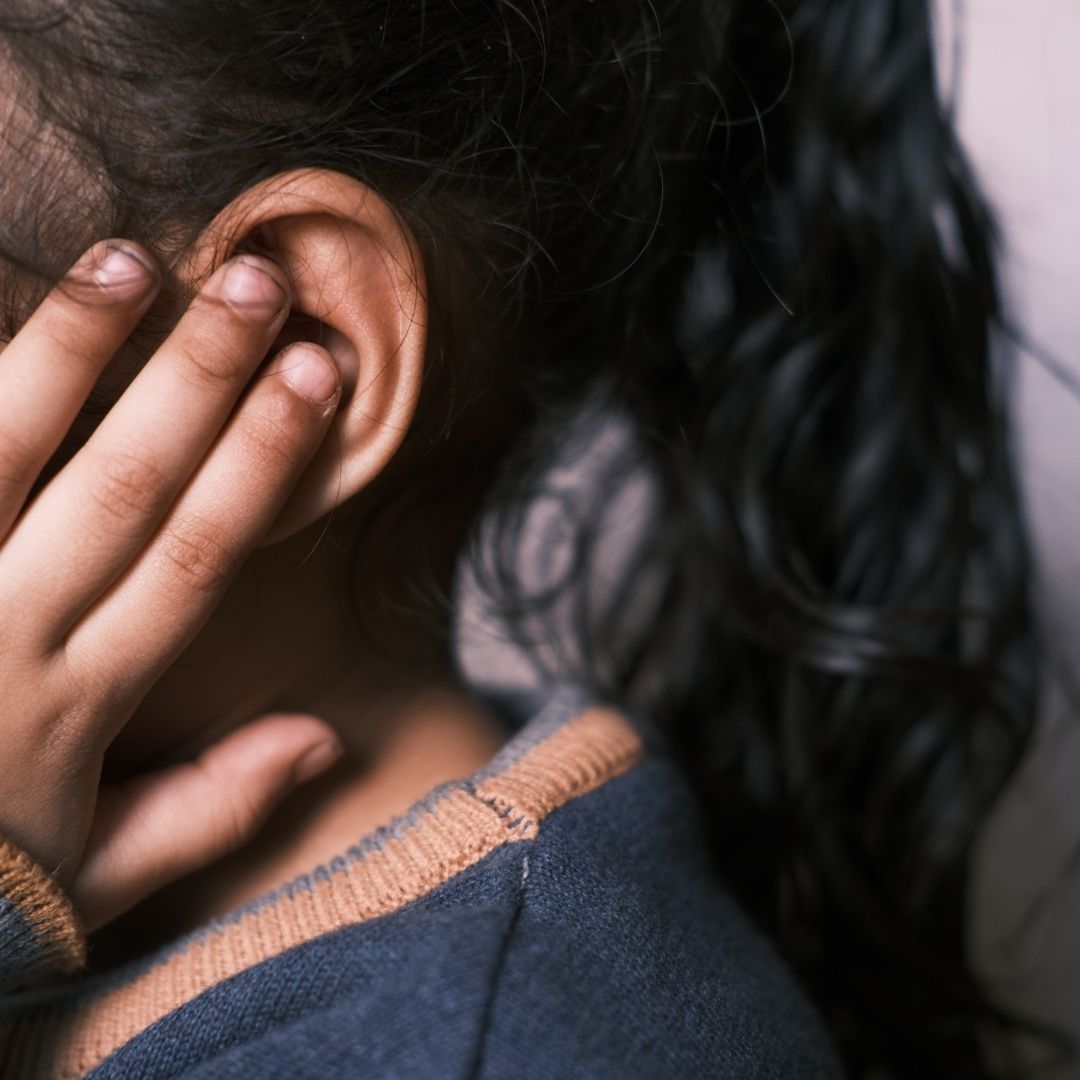person touching ear